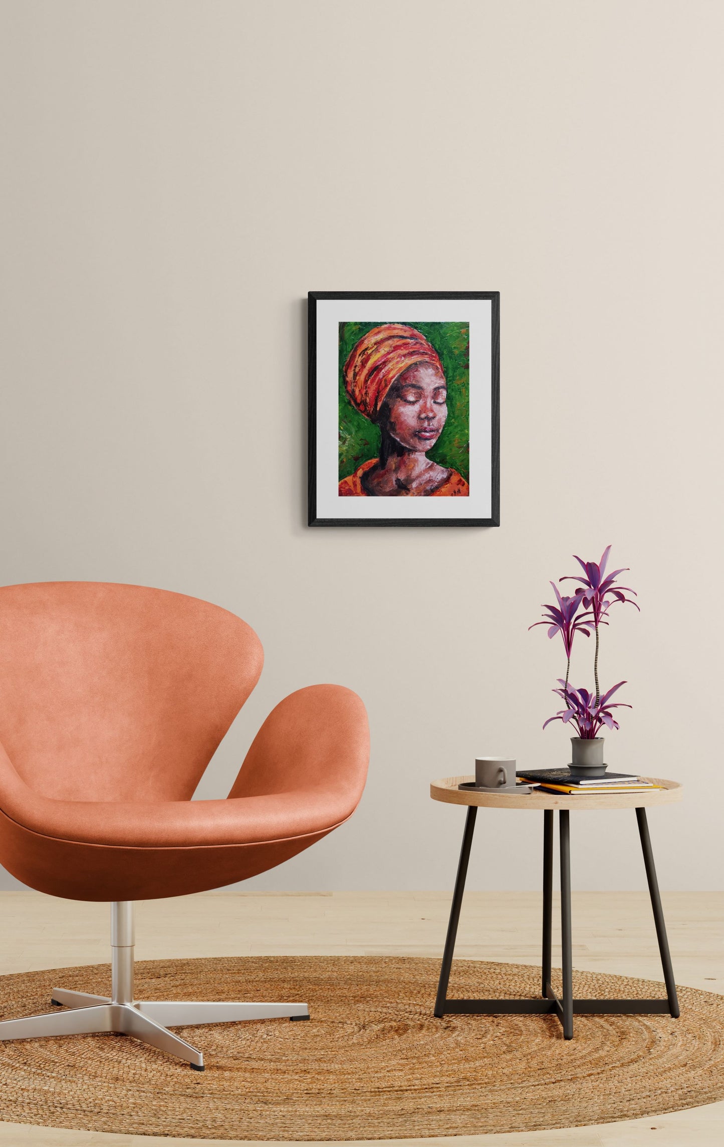 Modern interior with a pink chair, small table, and framed artwork on a beige wall.