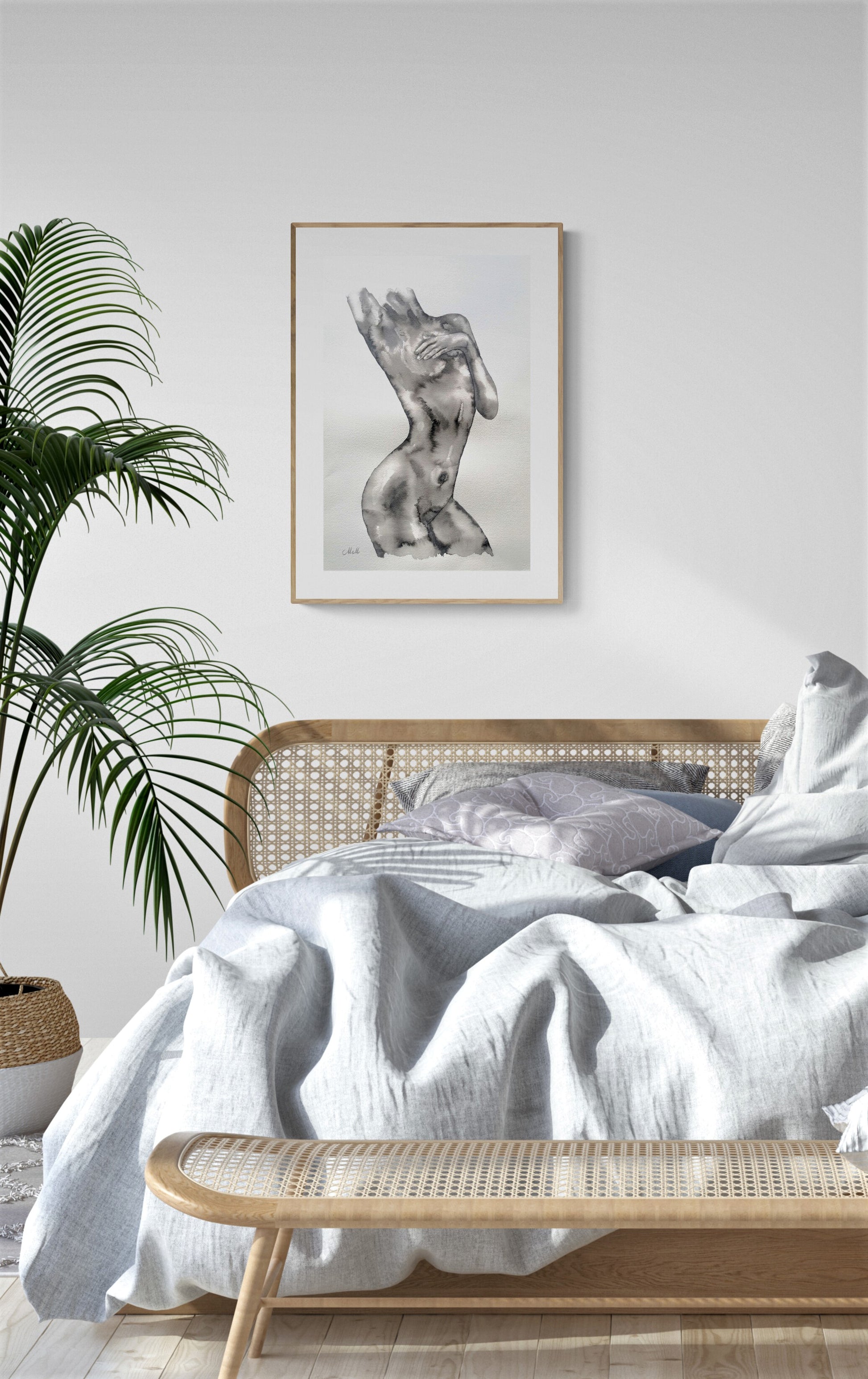 Bedroom with white bedding, wooden bench, and framed artwork on a white wall.