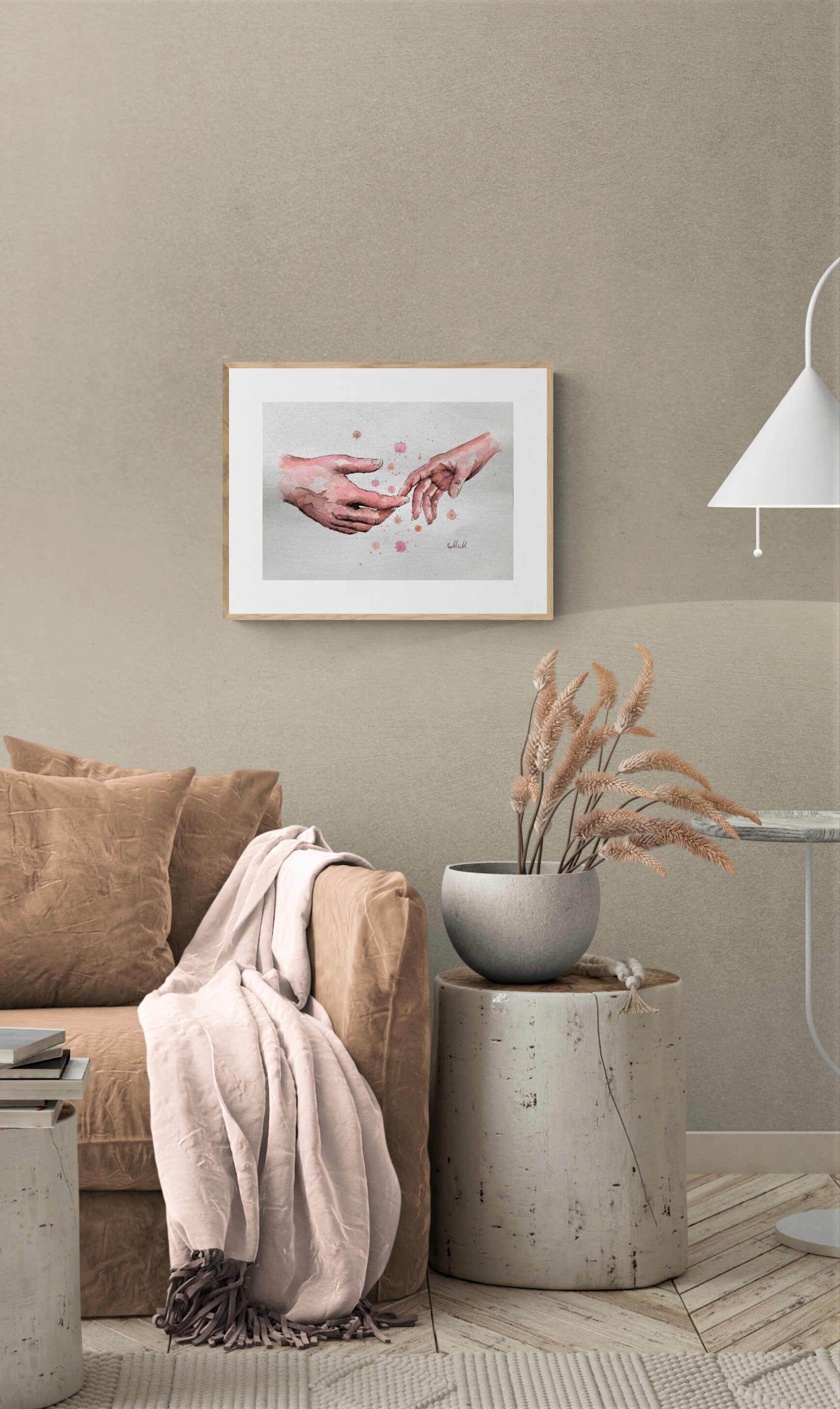 Living room with a beige sofa, decorative plant, and framed artwork on a wall.
