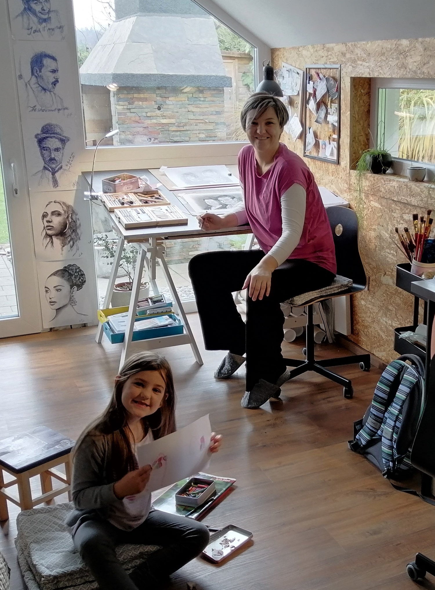 Portrait painter Mateja Marinko in her art studio creating portrait paintings: original oil portraits, holding hands watercolor and ink art, erotic artwork and charcoal female figure drawings