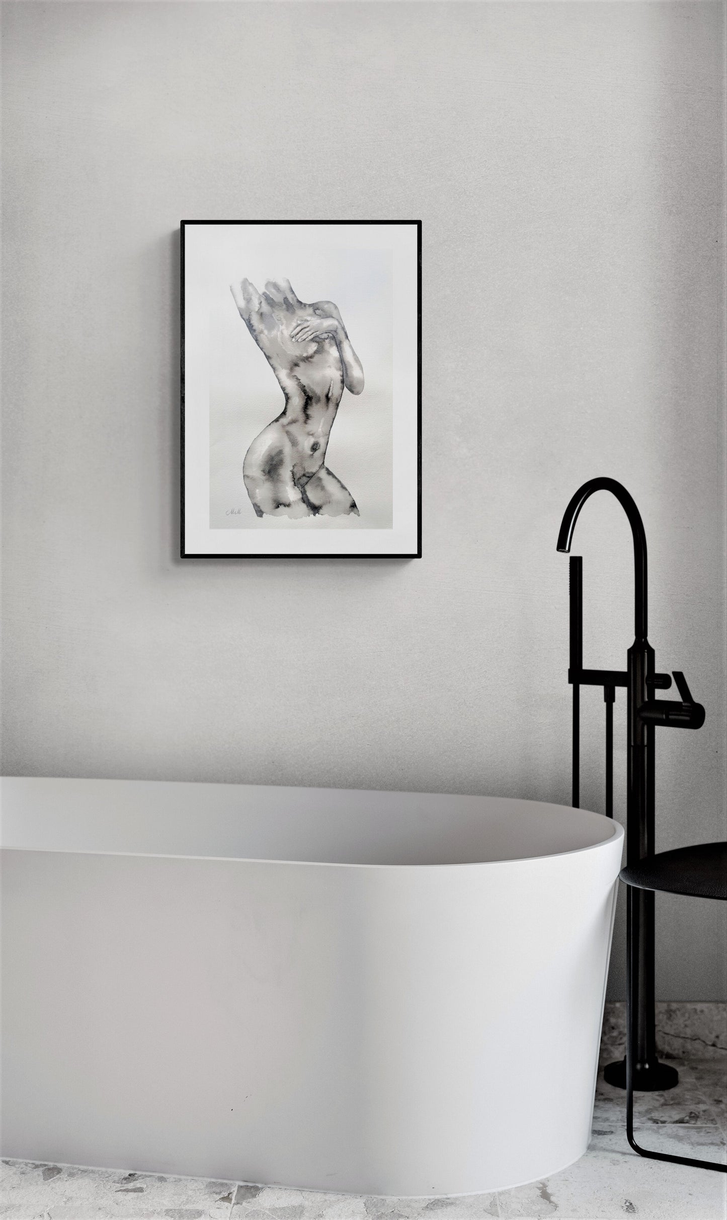 Modern bathroom with a freestanding bathtub, black faucet, and framed artwork on the wall.