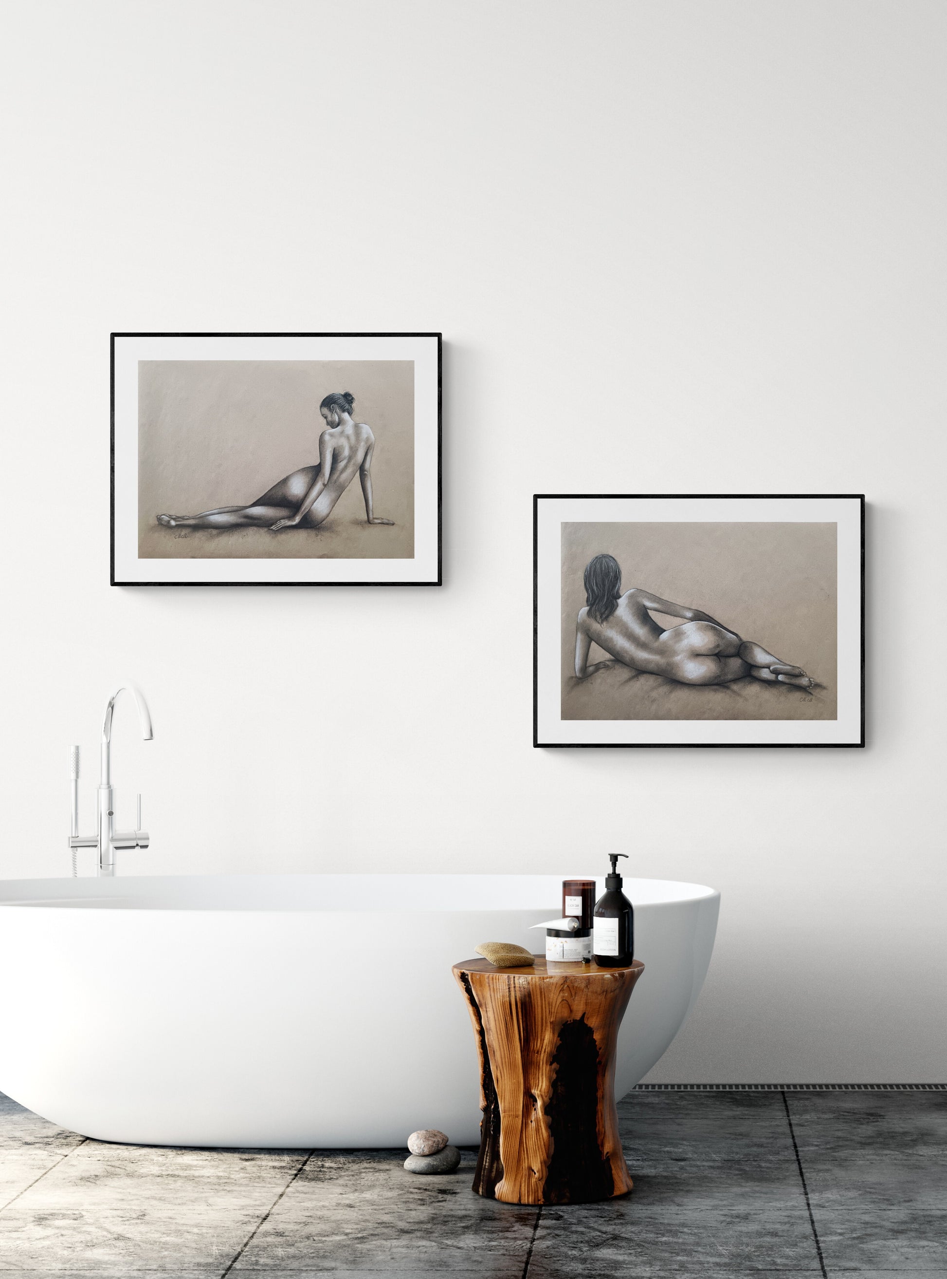 Bathroom interior with framed artworks of nude figures on a white wall.