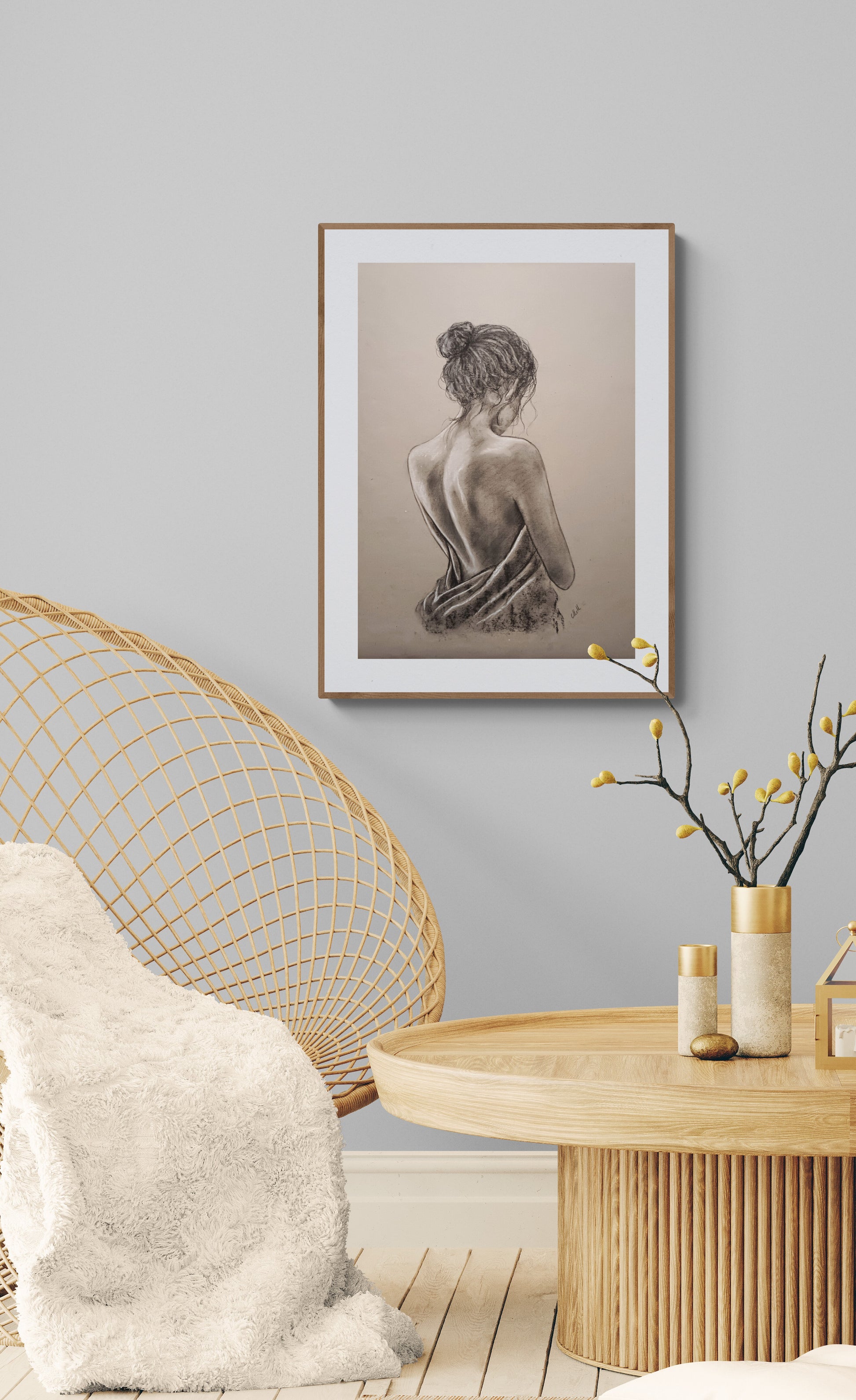 Framed artwork on a wall above a modern chair and table.