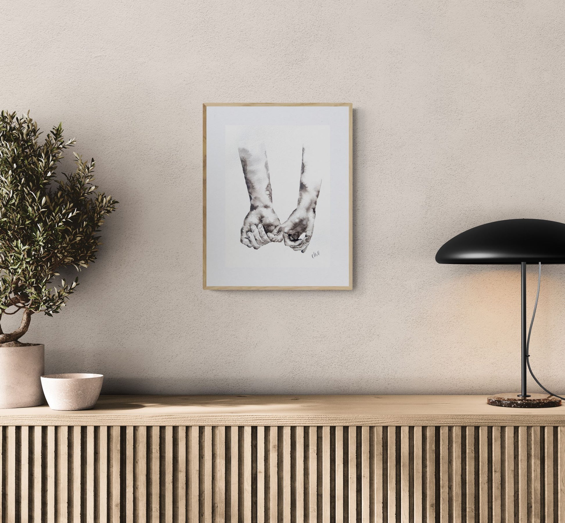 Framed artwork on a wall above a wooden console table with decorative items.