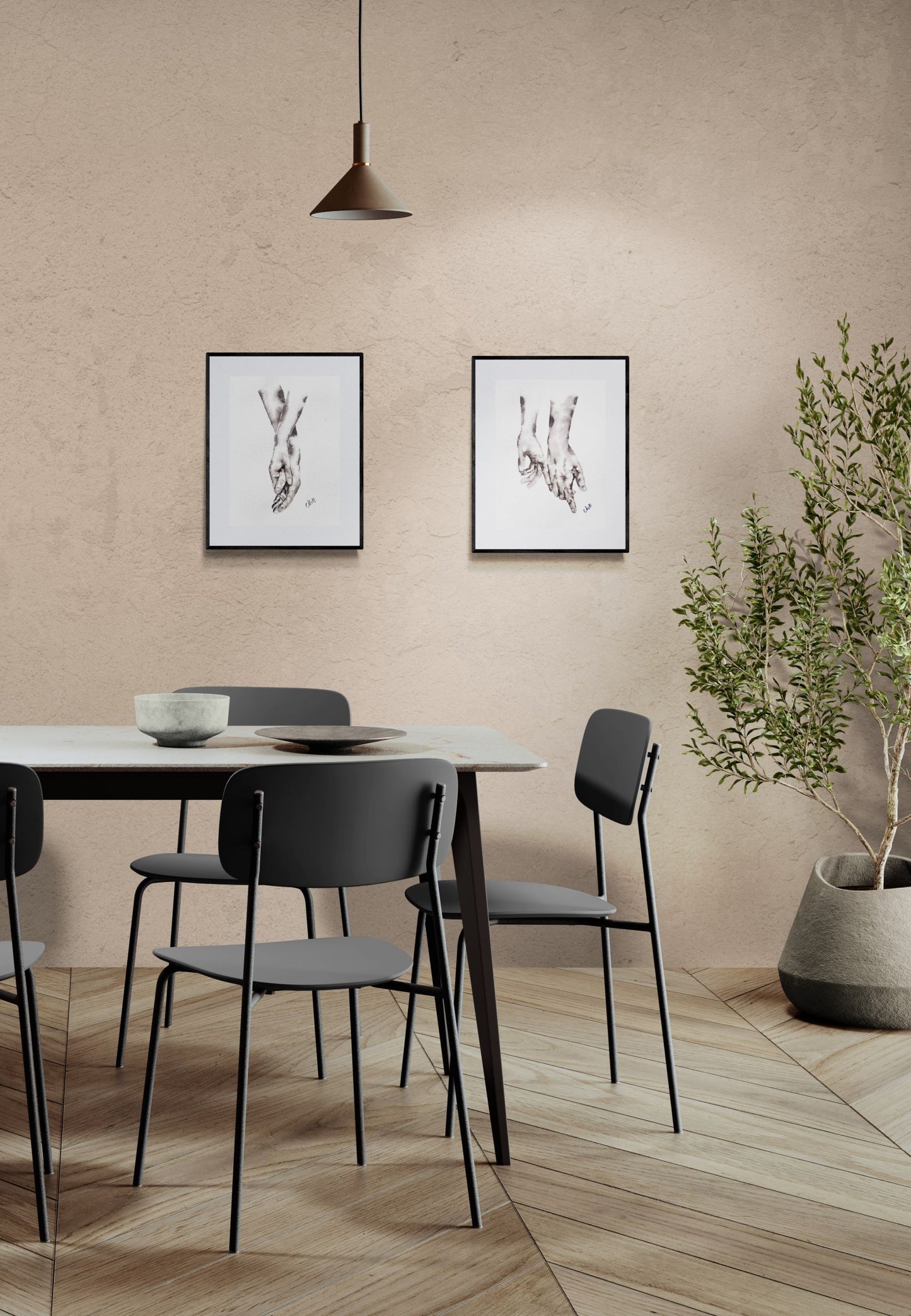 Dining area with a table and chairs against a beige wall with framed artwork.