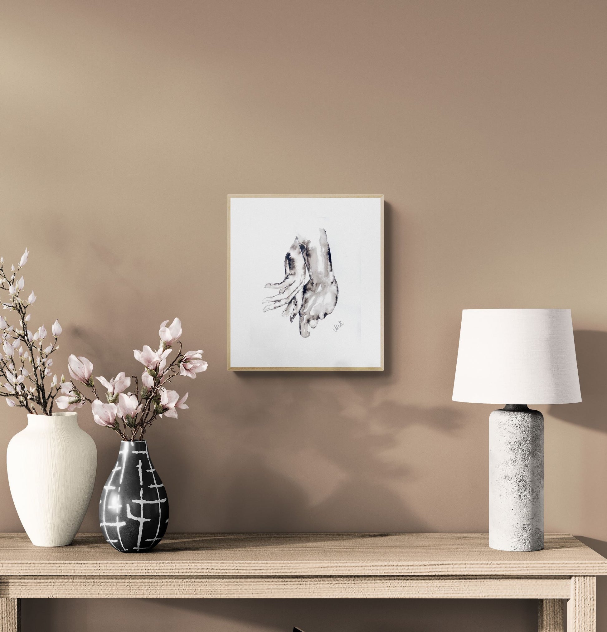 Decorative setup with vases, a lamp, and a framed picture on a beige wall.