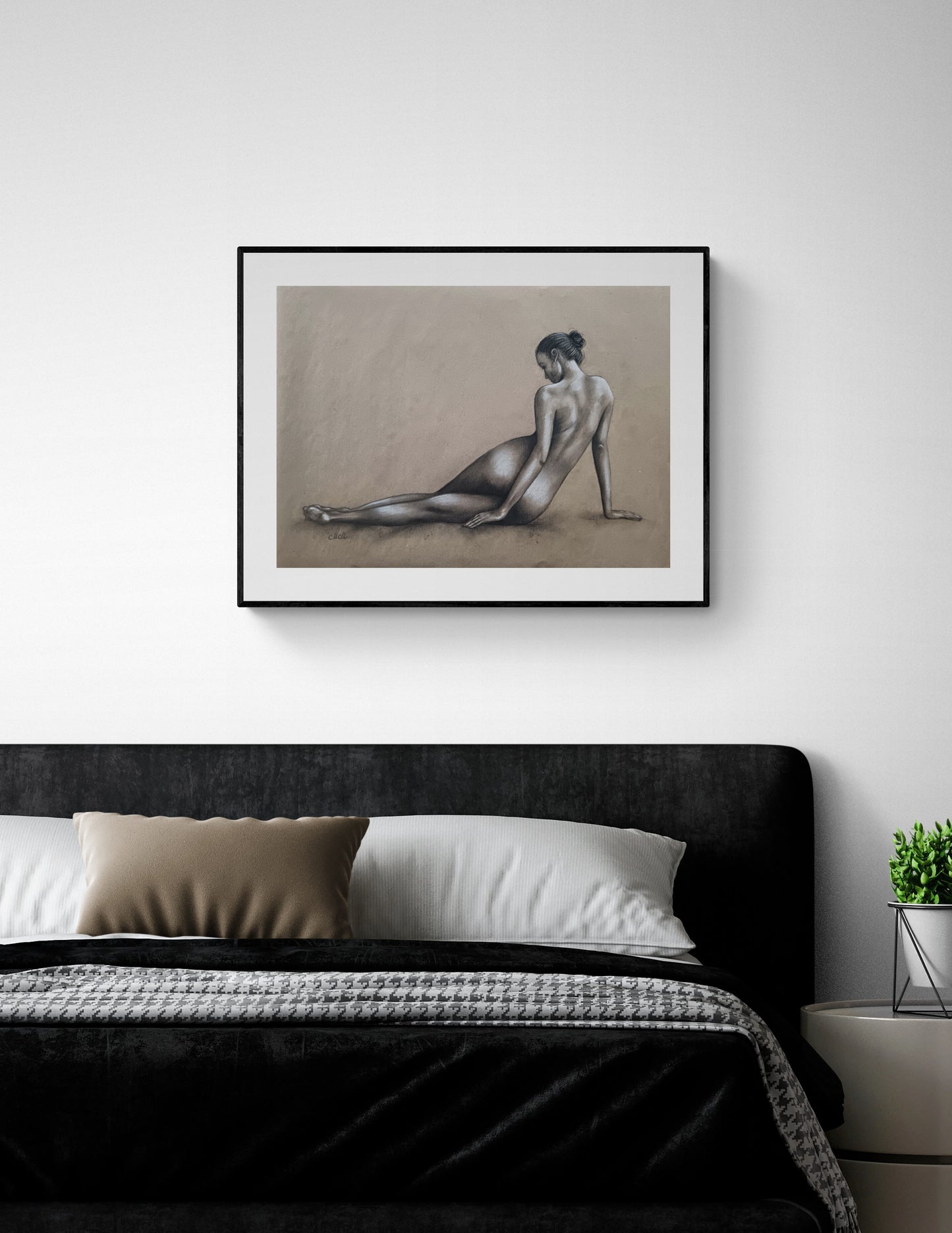 Framed artwork of a nude figure on a wall above a bed in a bedroom.