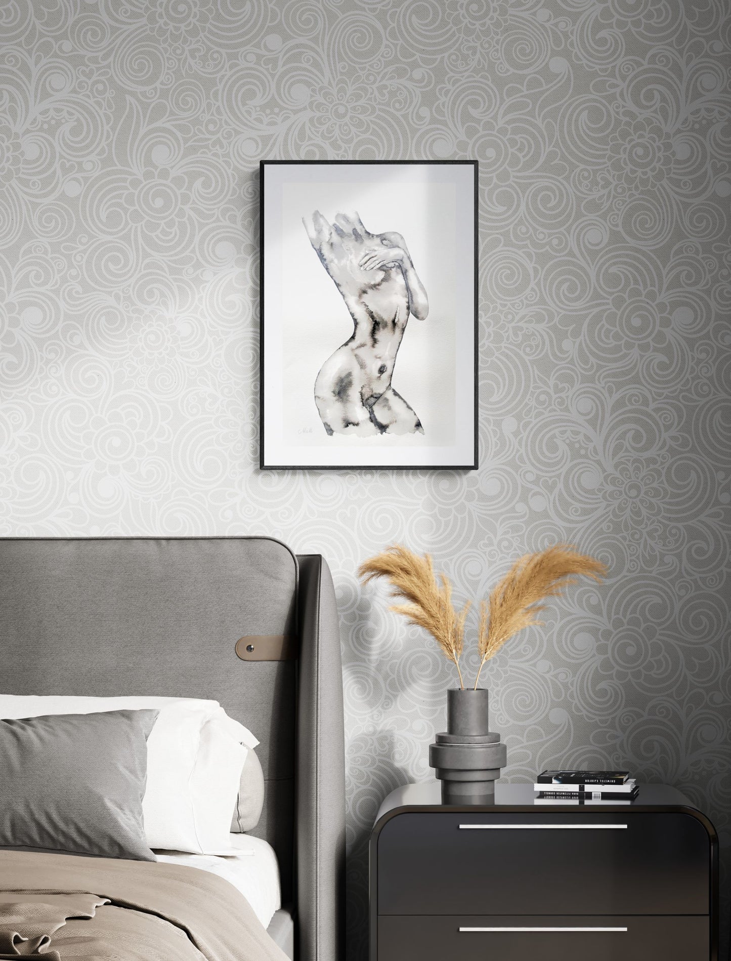 Decorative scene with a framed artwork above a bed and a nightstand with a vase and books.
