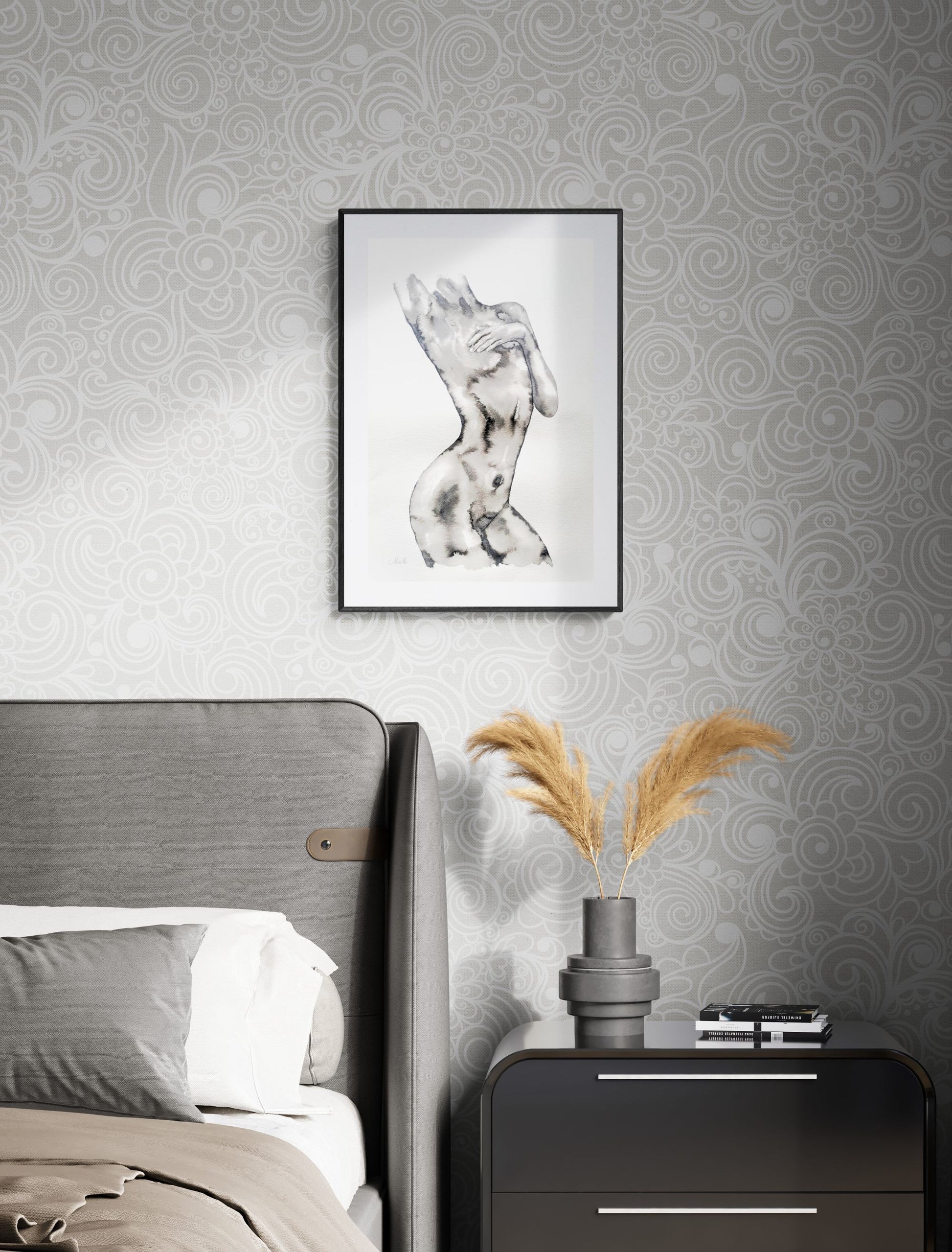 Decorative scene with a framed artwork above a bed and a nightstand with a vase and books.
