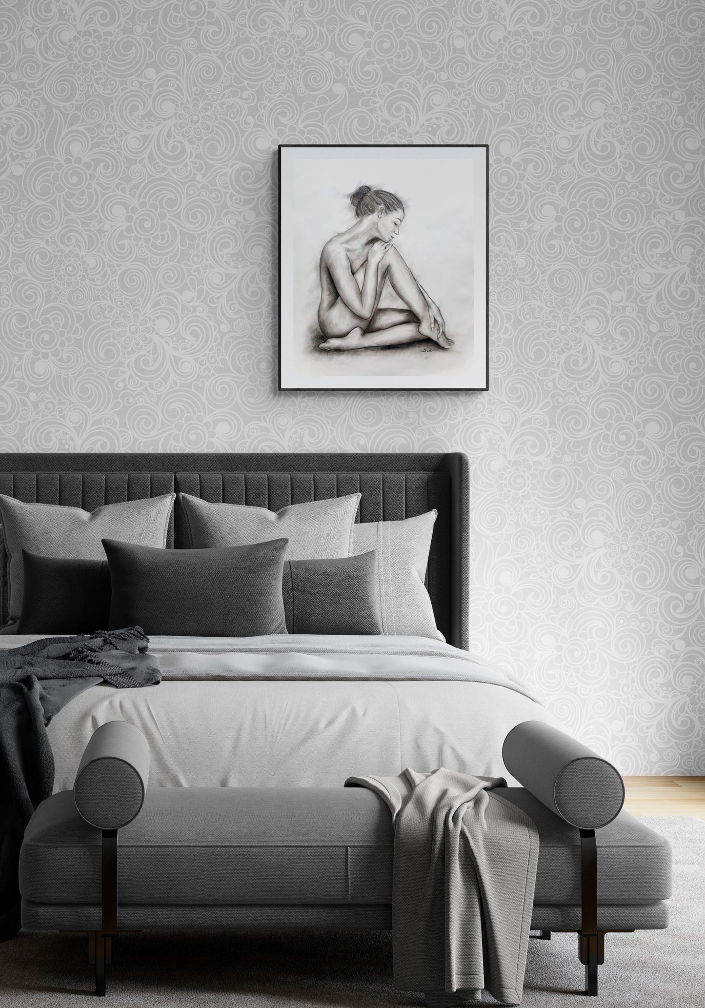 Modern bedroom with a bed, ottoman, and framed artwork on the wall.