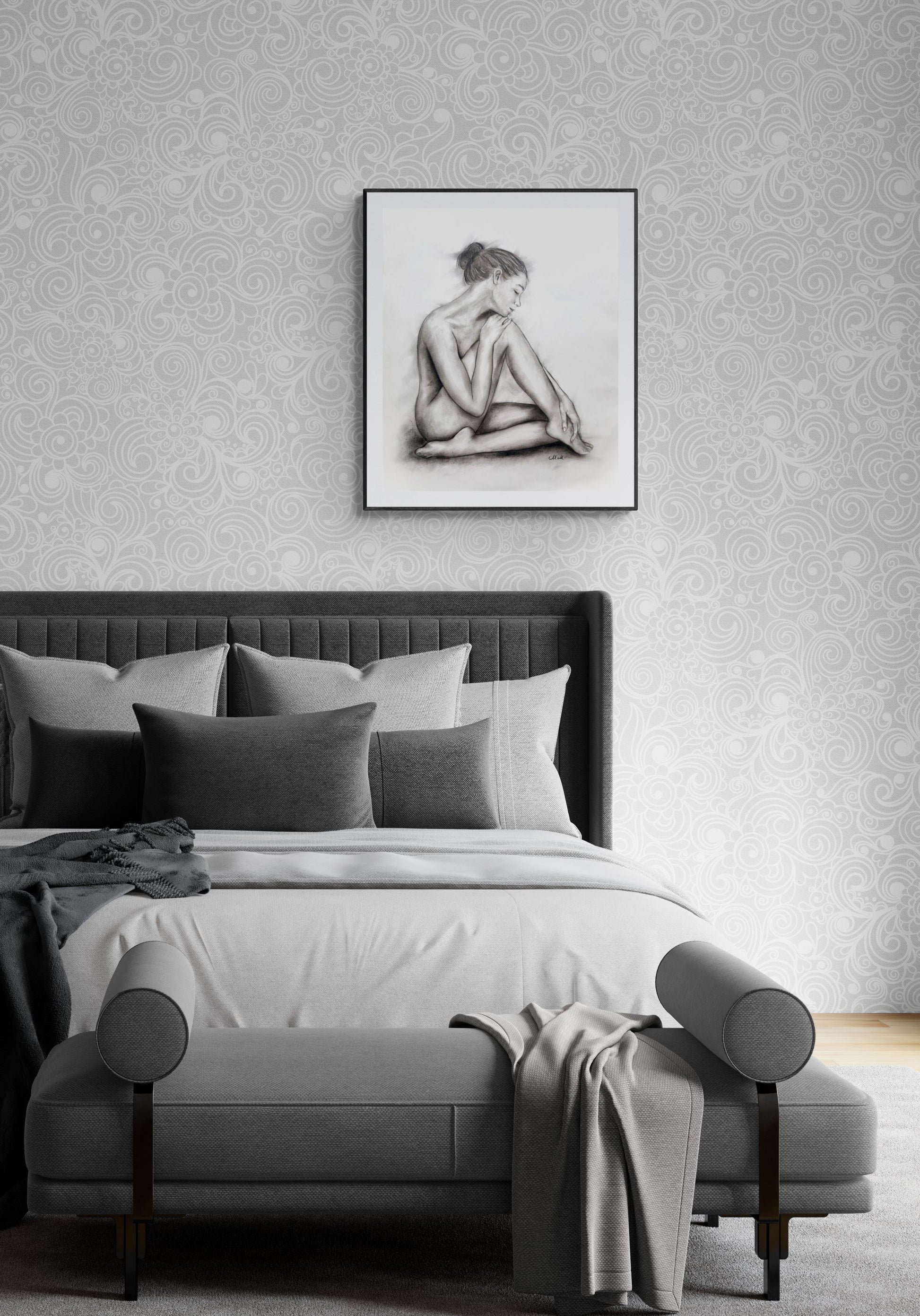 Modern bedroom with a bed, ottoman, and framed artwork on the wall.
