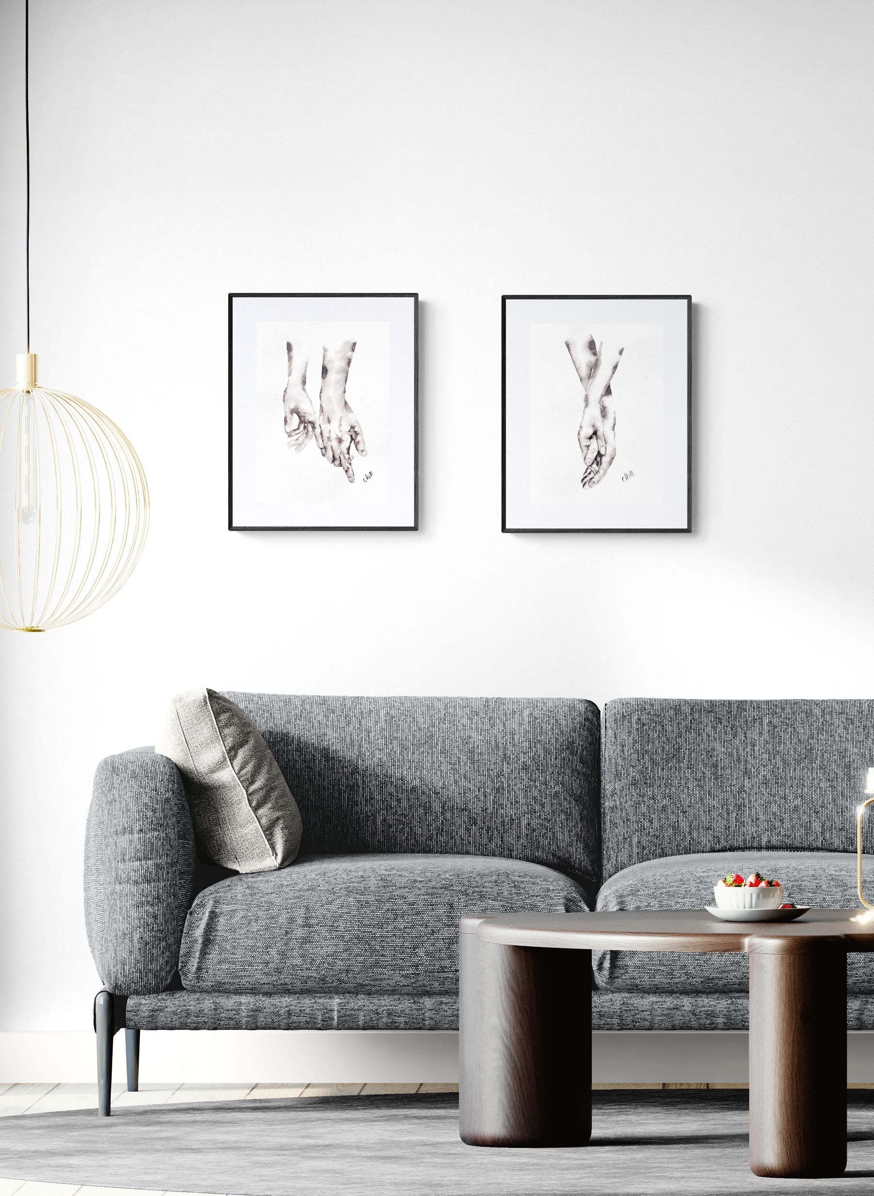 Modern living room with a gray sofa, coffee table, and framed artwork on the wall.